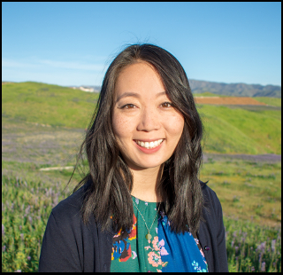 Dr. Alayna Park, Assistant Professor at Palo Alto University and UCLA Clinical Psychology graduate, smiling in an outdoor headshot with rolling green hills in the background.