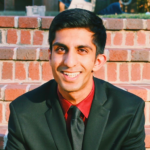 Vansh Bansal, M.A., Virginia Tech, smiling while sitting on brick steps outdoors, author of a report on digital therapy platforms and telehealth services.